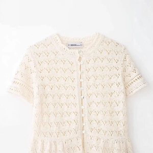Chic cream openwork lace knit short sleeve cardigan with buttons shown in a flat lay view