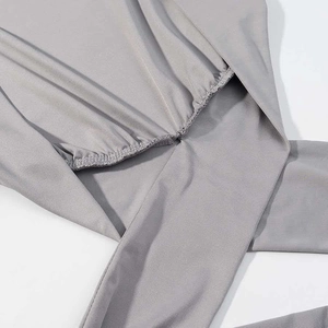 Close-up of grey sleeveless top fabric showing elastic ruched details and soft texture