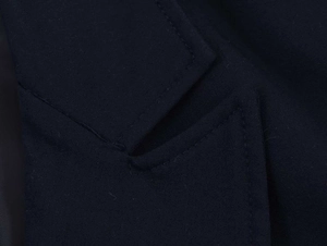 Detail of the navy blue blazer neckline showing high-quality stitching and fabric texture