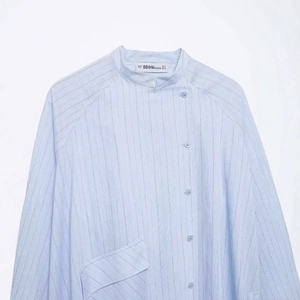 Women's casual light blue vertical striped long sleeve shirt with a unique side button collar