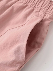Macro detail of elastic waistband and side pocket on dusty rose quick-dry casual pants