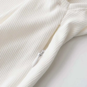 White ribbed t-shirt with ruffle hem featuring a concealed side zipper detail