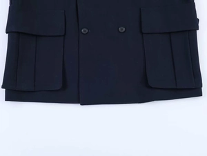Close-up of navy blue double-breasted blazer with cargo pockets and metallic buttons