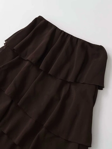Detailed macro view of the dark brown tiered chiffon skirt waist with ruffled layers