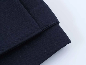 Detail shot of the navy blue blazer sleeve cuff showing precise stitching and fabric texture
