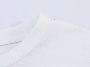 Close-up of the crew neck collar on a white cotton T-shirt with fine stitching details