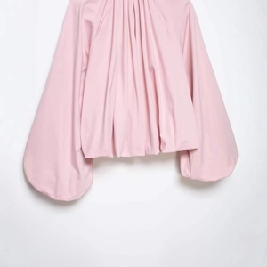 Fashionable pale pink shirt for women with puff sleeves and elegant pleated neckline