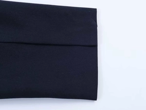 Detail of dark navy blazer fabric showing premium textured weave and flat hem finish