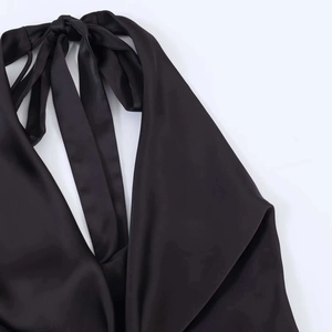 Close-up of black satin halter neckline with elegant back tie-up bow detail