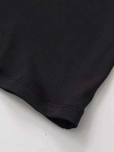 Detail of double-needle stitching and neat hemline on a black lace waist skirt