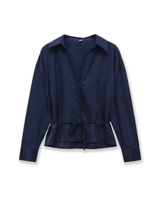 Detail of navy silk shirt with deep V-neck, waist tie, and glossy satin texture