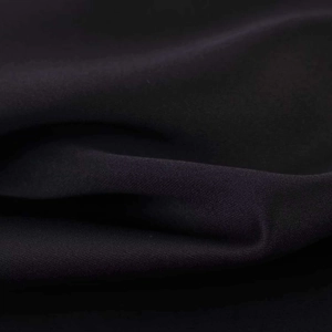 Detail shot of deep purple satin fabric showing smooth texture and soft elegant drapes