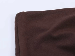 Detailed close-up of dark coffee brown knit fabric texture and premium stitching