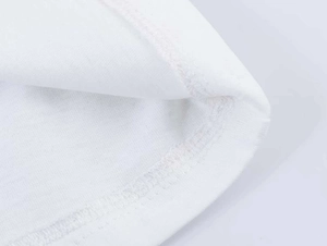 Close-up of high-quality double-needle stitching on a white cotton blend T-shirt fabric