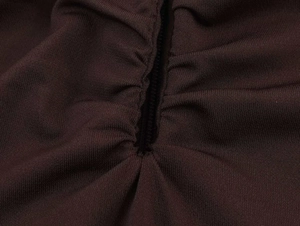 Detailed close-up showing the gathered stitching and ruched texture on brown fabric
