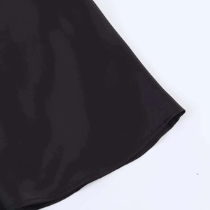 Detailed view of the smooth black satin fabric hem with high-quality stitching craftsmanship
