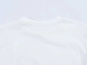 Detailed close-up of white cotton T-shirt crew neck showing fine double-needle stitching