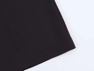 Detailed view of the neat hem stitching on a black commute style women's suit set