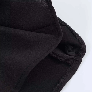 Close-up of premium black satin fabric with precision stitching and hemmed edge detail