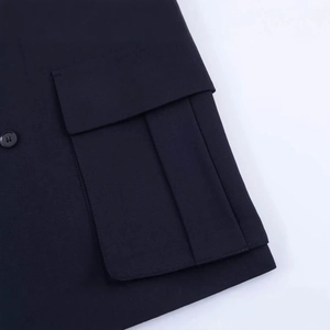 Navy blue double-breasted blazer featuring flap pocket detail and a textured fabric finish