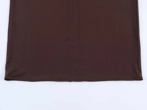 Detail view of double-needle hem stitching on brown sleeveless strapless dress fabric