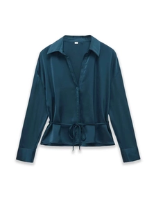 Detail of teal satin shirt featuring V-neckline, waist tie, and smooth silk-like texture