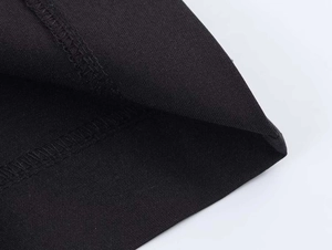 Macro detail of high-quality black twill fabric with professional edge stitching seams