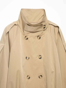Detail shot of khaki double-breasted trench coat with classic lapels and shoulder epaulettes