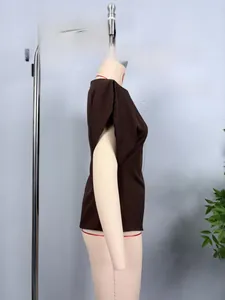 Detail view of dark brown puff sleeve top with unique chiffon split shoulder design