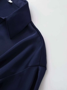 Detail view of smooth dark blue chiffon fabric texture and collar stitching on the blouse