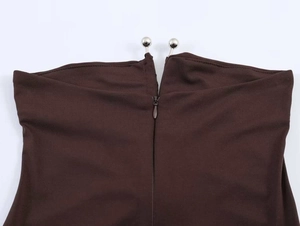 Close-up of invisible zipper and silver metal bead fasteners on dark brown strapless dress
