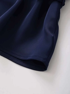 Close-up of deep blue blouse hem featuring professional double-needle stitching detail