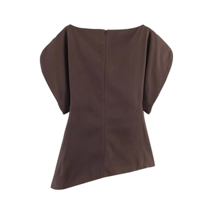 Detail of loose fit dark brown puff sleeve top with asymmetrical hem and invisible zipper