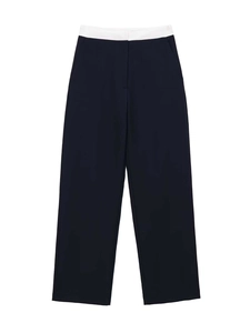 Detailed view of high-waist dark blue straight trousers with contrasting white waistband