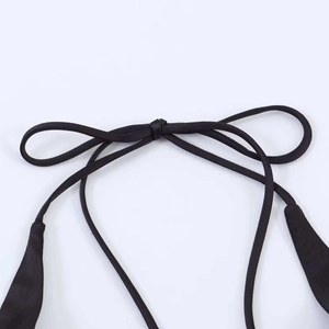 Detail of the black satin halter neck straps with a secure knotted tie design