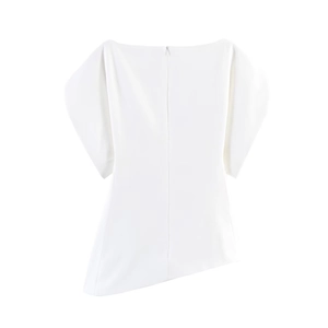 Detail of white boat neck top featuring architectural puff sleeves and asymmetric hemline
