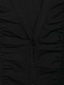 Detail view of black V-neck shirt featuring elegant ruching and matching round buttons
