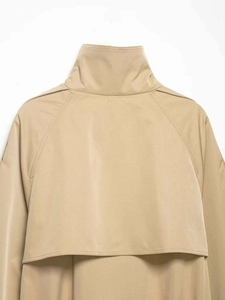 Detail view of khaki trench coat back yoke and high-density woven fabric texture