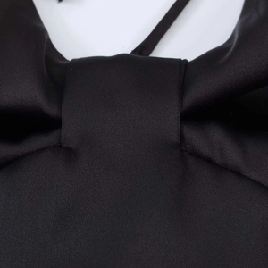 Detail of glossy black silk fabric texture on a backless halter top necktie section