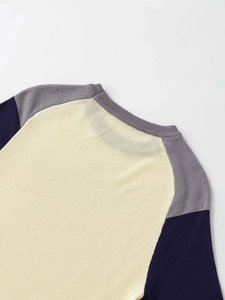 Detailed close-up showing the fine knit texture and neat stitching of the tricolor knit top