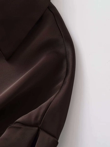 Macro shot of silk-like dark brown satin shirt detailing collar and fine stitching work