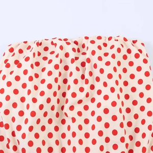 Polka dot strapless top with red dots on beige fabric and elastic smocked details