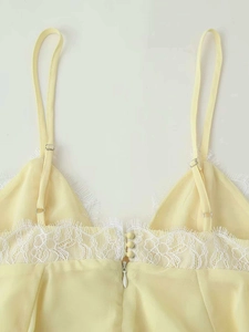 Detailed back view of yellow camisole with adjustable straps and white lace trim
