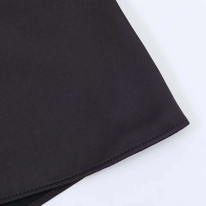 Close-up detail of neat single-needle stitching on black fabric edge for halter tops