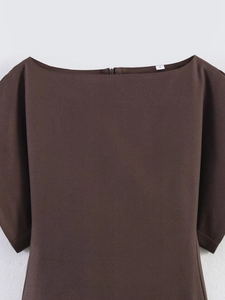 Detail of dark brown textured blouse featuring a boat neck and hidden back zipper