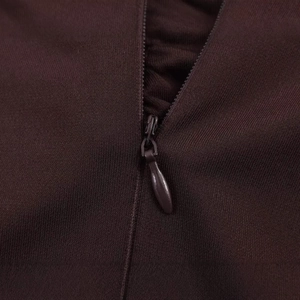 Detail of invisible zipper closure on a dark brown sleeveless strapless dress