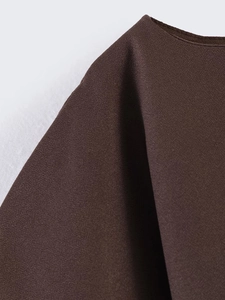 Detailed texture shot of dark brown chiffon fabric featuring a premium crepe-like finish