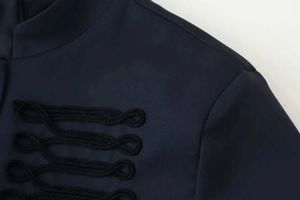 Close-up of decorative black braided frog fasteners on the navy blue military jacket
