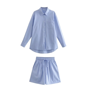 Close-up of light blue striped cotton shirt and matching drawstring shorts set