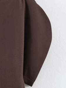 Close-up of structured puff sleeve detail on chocolate brown fashion top for women